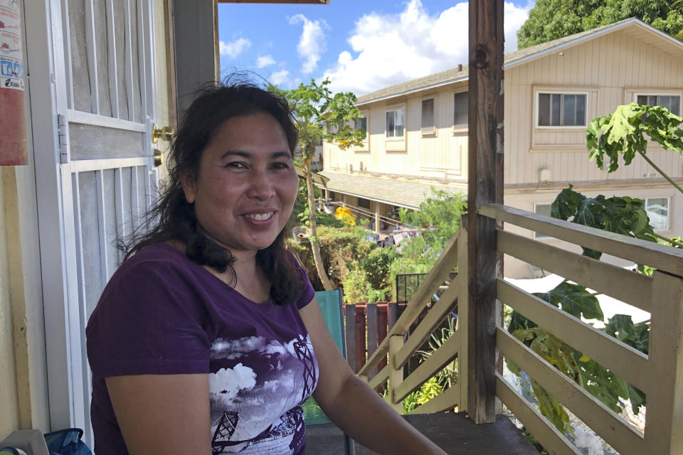 Susan Galicha poses for a photo on her front porch in Waipahu, Hawaii on Oct. 30, 2020.Honolulu is building one of the nation's most expensive rail lines to address some of the nation's worst traffic but tax revenue declines during the pandemic and spiraling costs mean it doesn't currently have enough money to finish the 20-mile route as planned. (AP Photo/Audrey McAvoy)