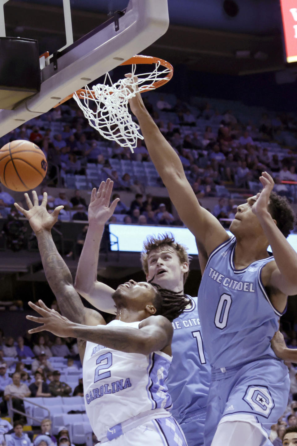 North Carolina guard Caleb Love (2) drives in against Citadel forwards Stephen Clark (1) and forward Jackson Price (0) during the first half of an NCAA college basketball game Tuesday, Dec. 13, 2022, in Chapel Hill, N.C. (AP Photo/Chris Seward)