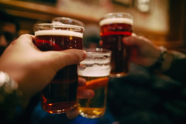 Friends raising a toast with some pints of beer