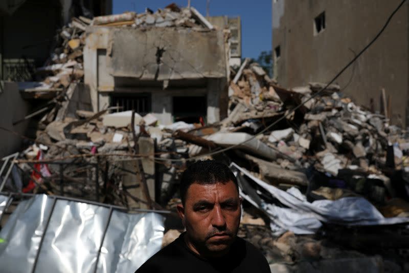 Syrian refugee Ahmed Staifi poses for a picture in front of the house were his wife and two of his daughters were killed following a massive explosion