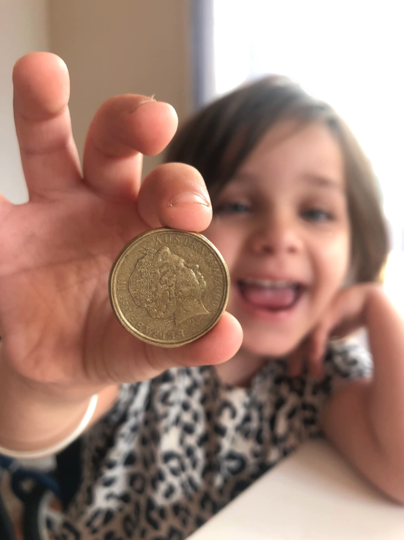 Smiing child with mule dollar. 