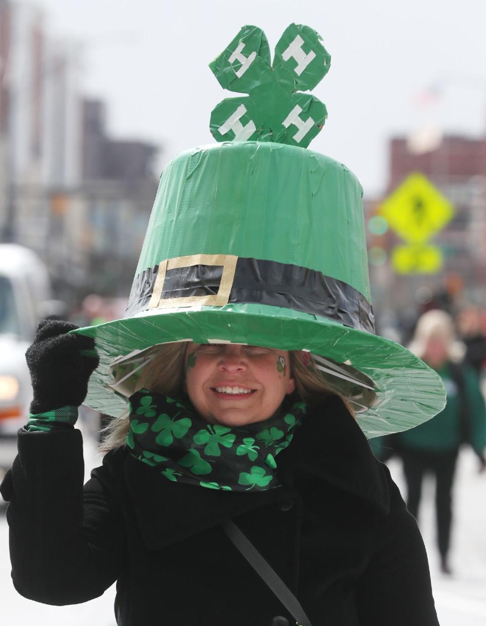 Gretchen Knapp wears an oversized 4H hat as she marches in The St. Patrick's Day Parade on Main Street in Akron.