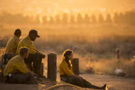 Firefighters rest during a wildfire in Yucaipa, Calif., Saturday, Sept. 5, 2020. Firefighters trying to contain the massive wildfires in Oregon, California and Washington state are constantly on the verge of exhaustion as they try to save suburban houses, including some in their own neighborhoods. (AP Photo/Ringo H.W. Chiu)