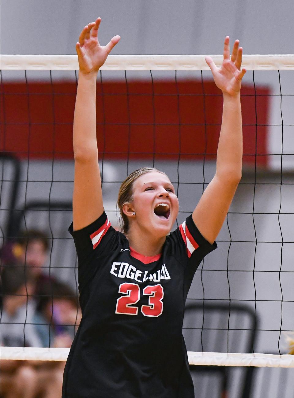 Edgewood’s Gracie Farmer (23) celebrates after winning a point during the volleyball match against Bloomington North at Edgewood on Thursday, Sept. 28, 2023.