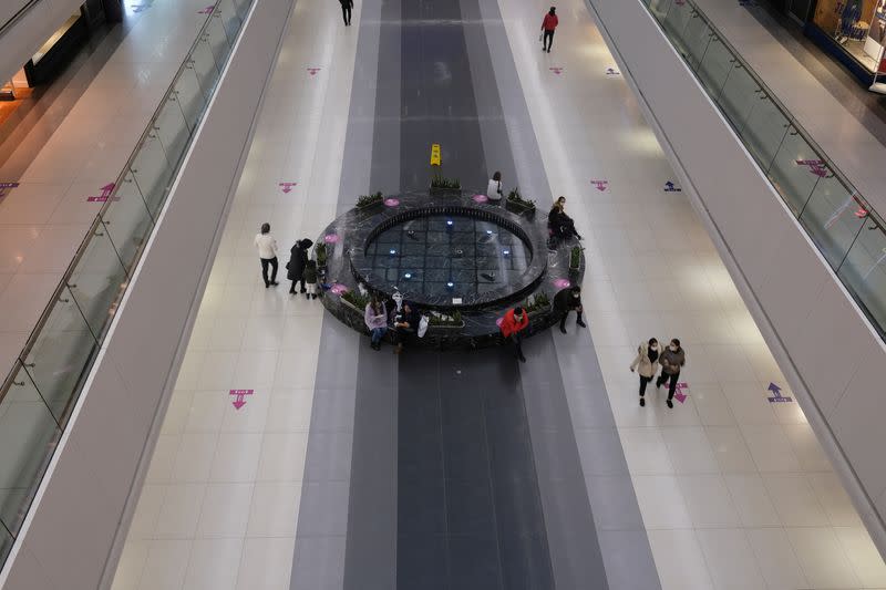 FILE PHOTO: Direction and social distancing signs are seen on the floor at a shopping mall in Istanbul
