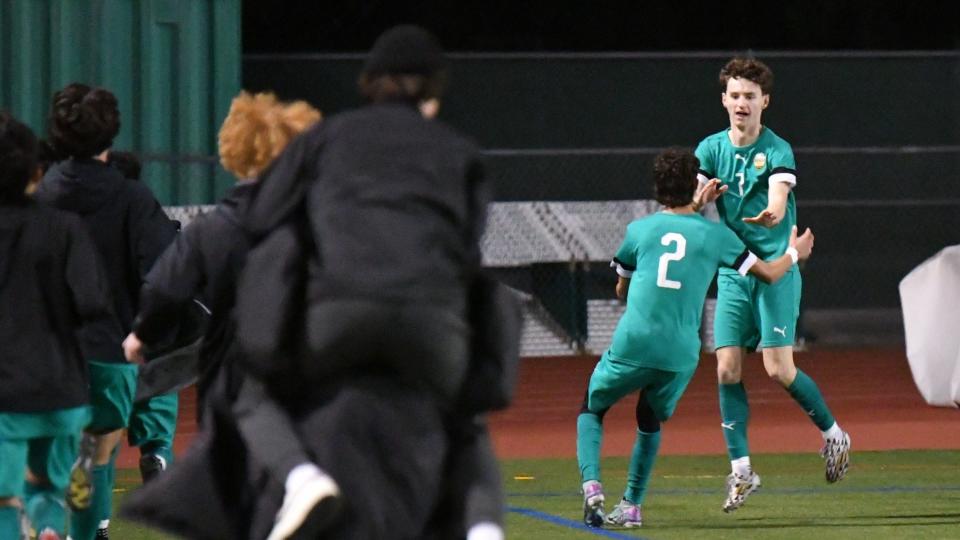 Thousand Oaks High's Mikey Houghtaling celebrates with Kevin Parker (2) after scoring the game's only goal in the Lancers' 1-0 win over Agoura in a Marmonte League showdown at Thousand Oaks on Tuesday, Jan. 30, 2024. Thousand Oaks clinched the league championship.