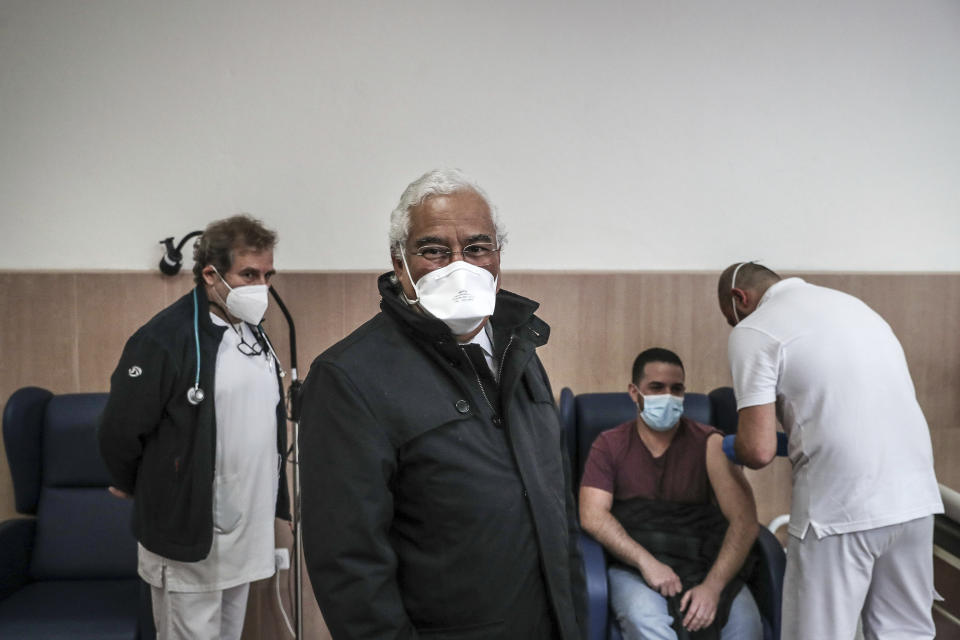 Portuguese Prime Minister Antonio Costa attends the vaccination against COVID-19 of prison workers at the Sao Joao de Deus prison hospital in Oeiras, outside Lisbon, Thursday, Feb. 4, 2021. The new head of Portugal's COVID-19 vaccination task force was due to start work Thursday, a day after his predecessor resigned amid scandals over vaccine queue-jumping and frustration over a sluggish rollout similar to that seen in other European Union countries. (Mario Cruz/Pool via AP)
