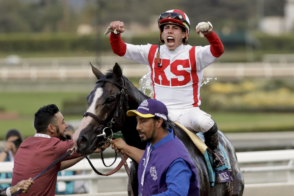 Irad Ortiz Jr. aboard Bricks and Mortar celebrates after winning the Breeders' Cup Turf horse race at Santa Anita Park, Saturday, Nov. 2, 2019, in Arcadia, Calif. (AP Photo/Gregory Bull)