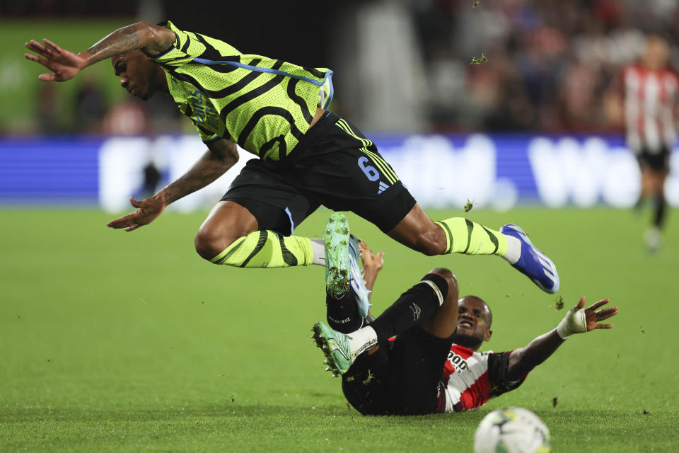 Arsenal's Gabriel, left, is tackled by Brentford's Frank Onyeka, during the English League Cup third round soccer match between Brentford and Arsenal at the Gtech Community Stadium, in London Wednesday, Sept. 27, 2023. (AP Photo/Ian Walton)