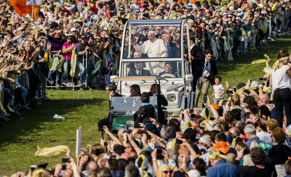 Pope Francis arrives in his popemobile in Monza, 30 kilometers north of Milan, Italy, to celebrate a Mass as part of his one-day pastoral visit to Monza and Milan, Italy’s second-largest city, Saturday, March 25, 2017. Pope Francis focused his one-day visit Saturday to the wealthy northern Italian city of Milan on those marginalized by society, visiting families in a housing project and exhorting clergy and nuns gathered in a cathedral to minister to the peripheries. (AP Photo/Giuseppe Aresu)