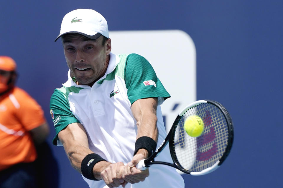 Roberto Bautista Agut of Spain returns to Jannik Sinner of Italy during the semifinals of the Miami Open tennis tournament, Friday, April 2, 2021, in Miami Gardens, Fla. (AP Photo/Lynne Sladky)