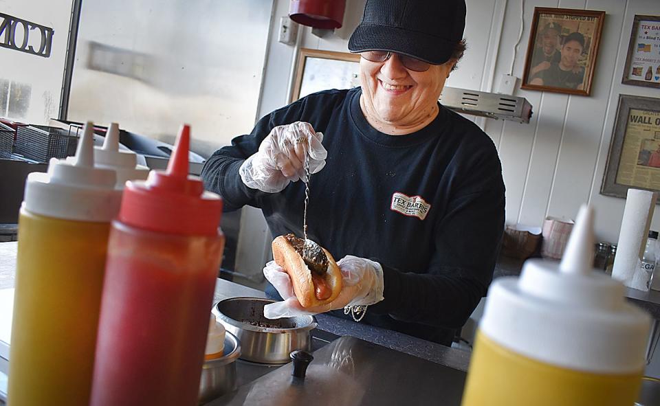 Janet Wetherell of Fall River makes a Coney dog at Tex Barry's Coney Island in Taunton in this 2023 file photo.