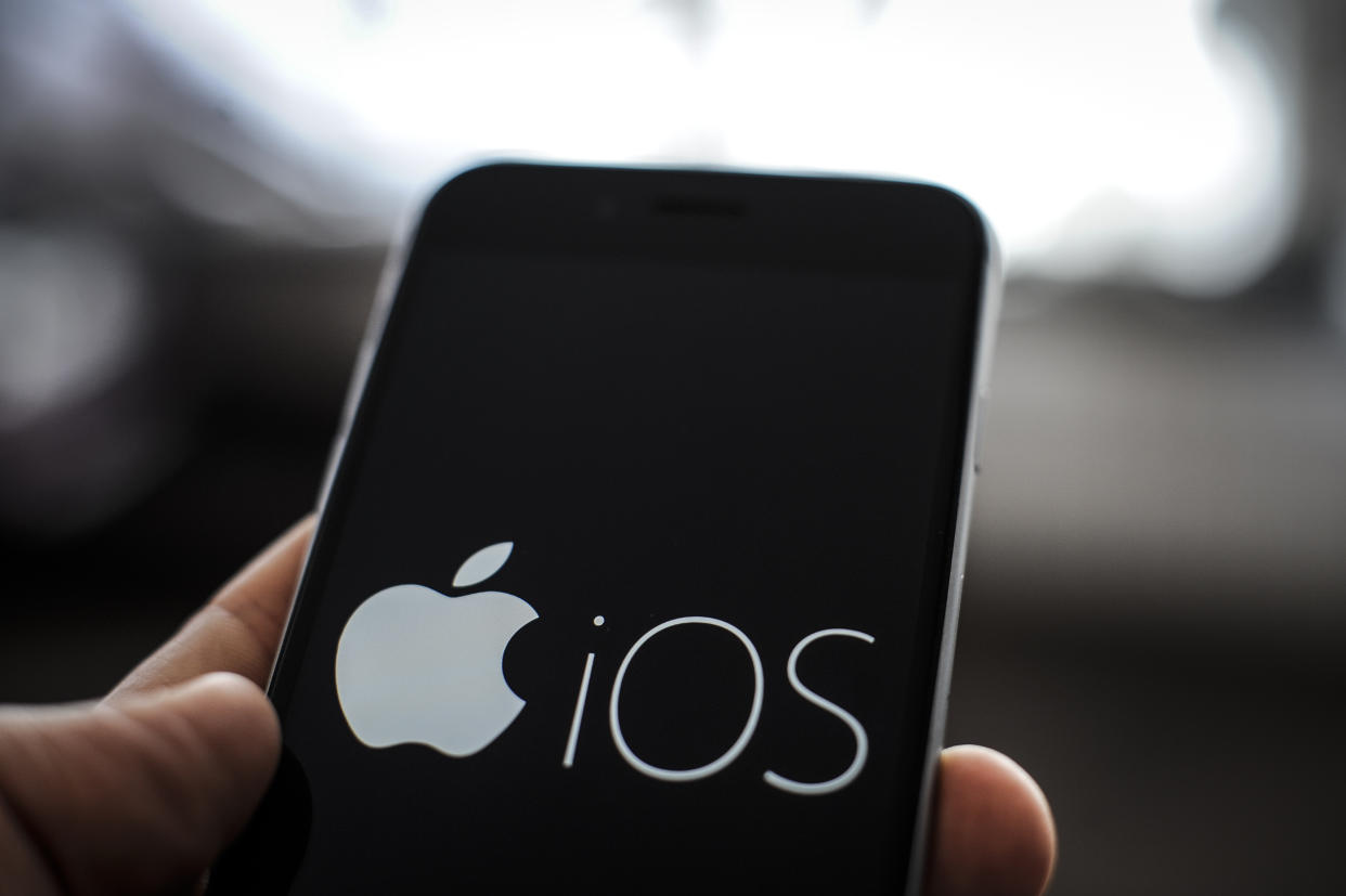 The Apple iOS logo is seen on an Apple iPhone on October 1, 2018. Apples latest realese of its mobile device operating system, version 12 has been plagued by bugs which can send messages to unintended recipients due to a feature which bundles same users who have multiple phone numbers. (Photo by Jaap Arriens/NurPhoto via Getty Images)