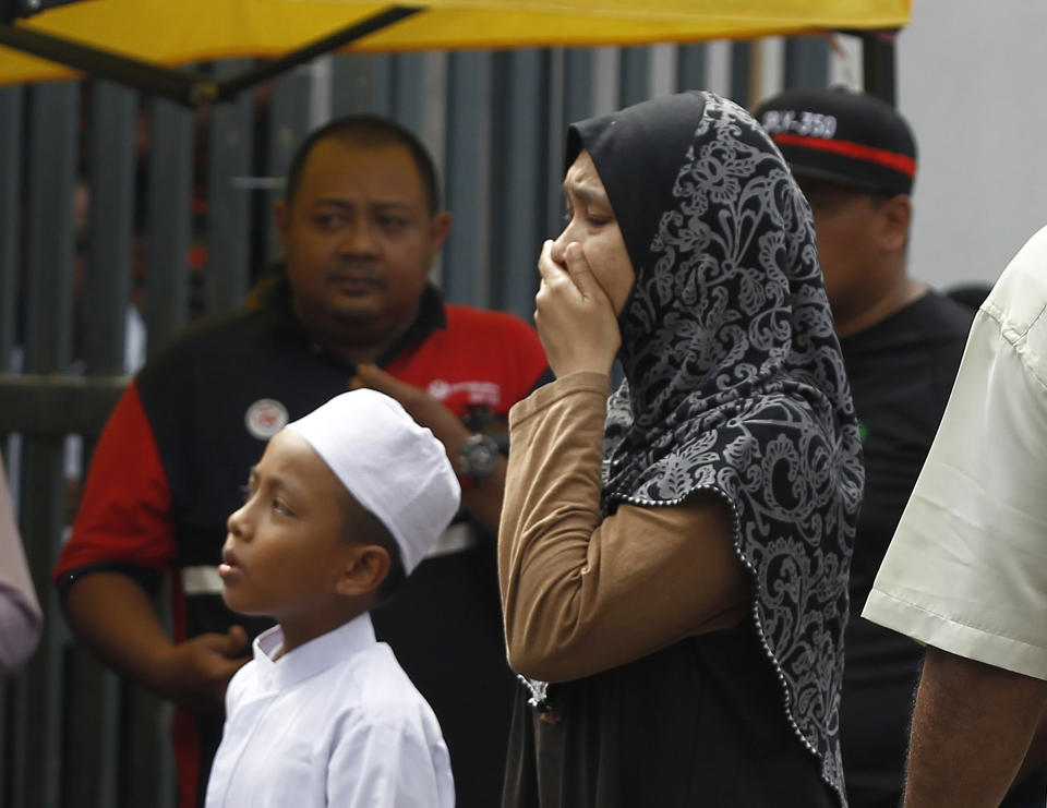 <p>Unidentified Muslim cry outside an Islamic religious school following a fire on the outskirts of Kuala Lumpur Thursday, Sept. 14, 2017. (Photo: Daniel Chan/AP) </p>