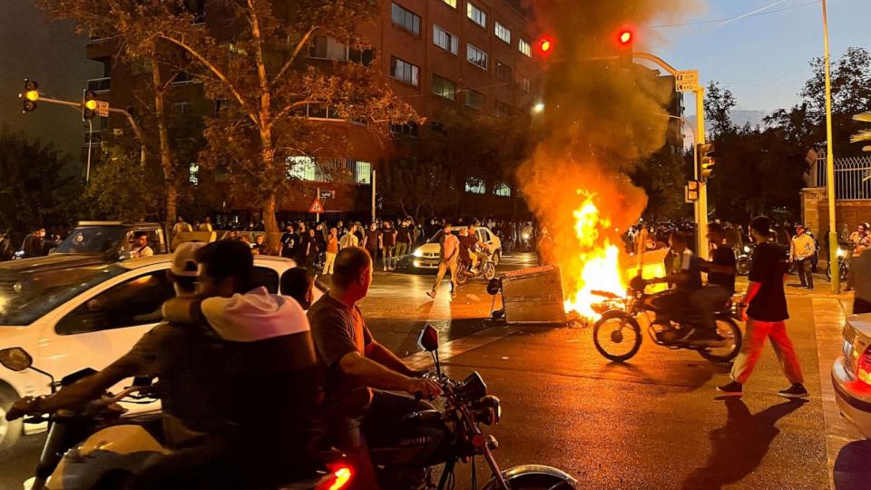 PHOTO: A police motorcycle burns during a protest over the death of Mahsa Amini, a woman who died after being arrested by the Islamic republic's 'morality police', in Tehran, Iran Sept. 19, 2022. (Wana News Agency/Reuters)