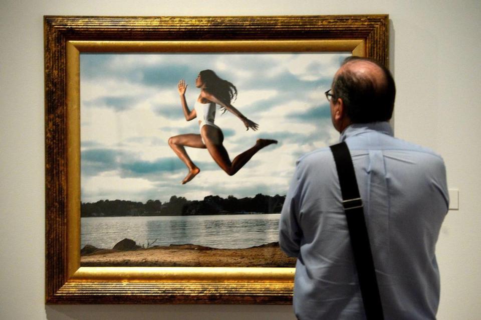 This image by Kevin “Surf” Mitchell, “High Jumper,” 2023, captures a woman in motion at Lake Norman.