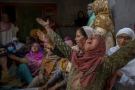 Relatives wail during the funeral of Waseem Ahmed, a policeman who was killed in a shootout, on the outskirts of Srinagar, Indian controlled Kashmir, Sunday, June 13, 2021. Two civilians and two police officials were killed in an armed clash in Indian-controlled Kashmir on Saturday, police said, triggering anti-India protests who accused the police of targeting the civilians. (AP Photo/ Dar Yasin)