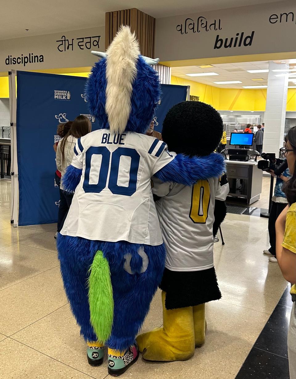 Avon High's oriole mascot Big O, played by Owen Carr, hangs out with Indianapolis Colts' Blue during a school appearance.