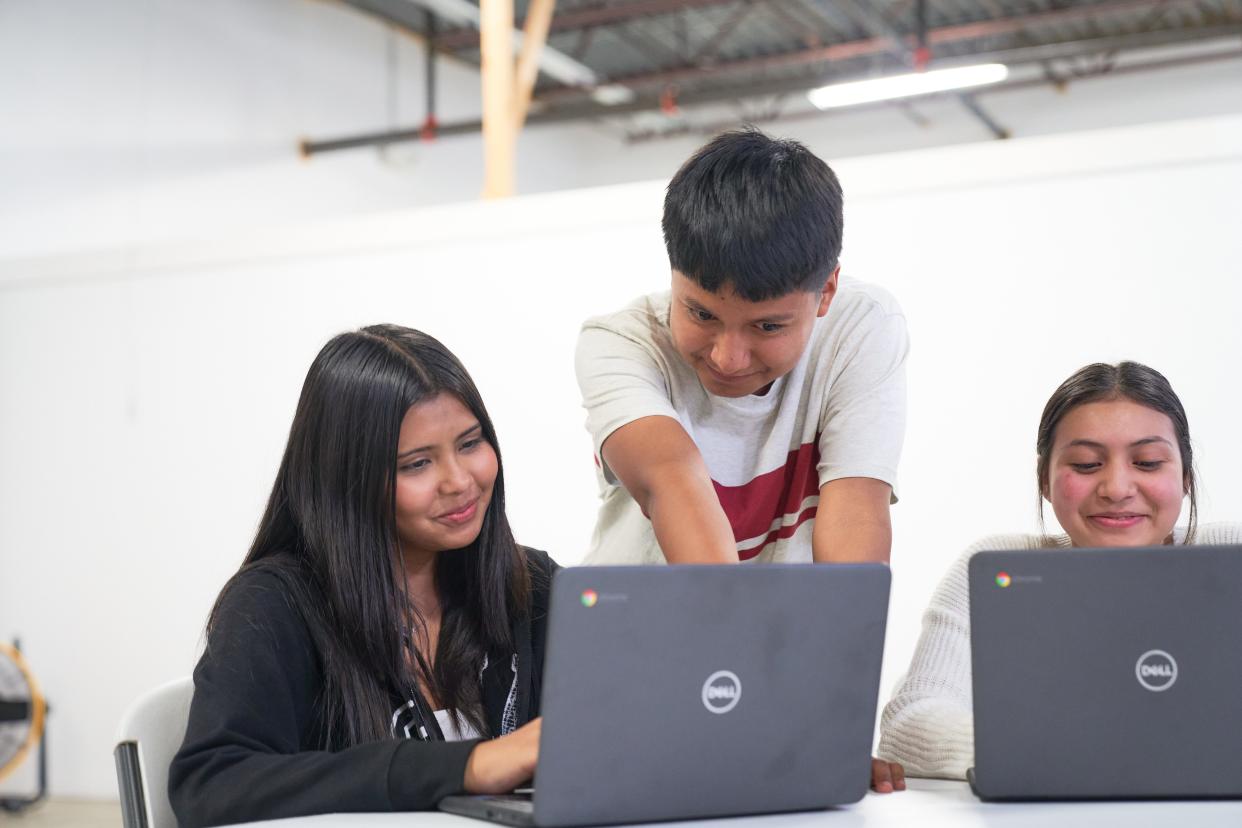 Dozens of Holland area students involved in Latin Americans United for Progress received laptops from Comcast this week in an effort to “bridge the digital divide.”