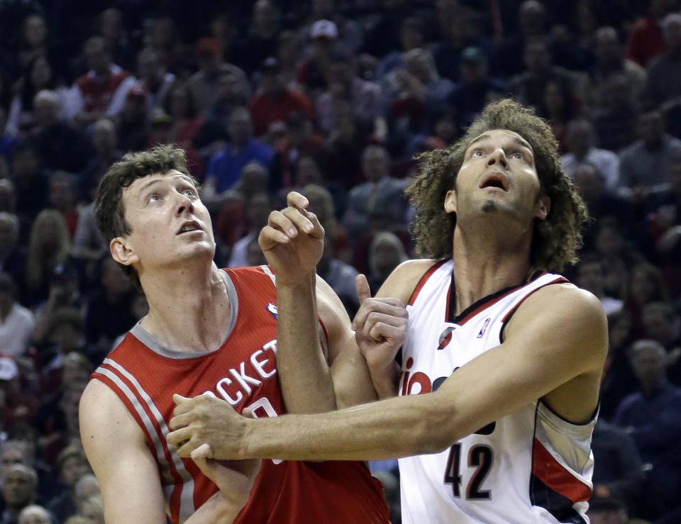Houston Rockets center Omer Asik, left, and Portland Trail Blazers center Robin Lopez jockey for position on a free throw during the first half of Game 3 of an NBA basketball first-round playoff series in Portland, Ore., Friday, April 25, 2014. (AP Photo/Don Ryan)