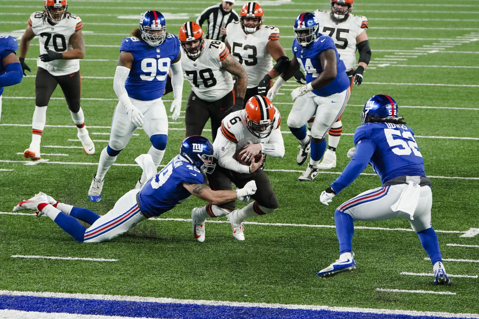 New York Giants linebacker Carter Coughlin (49) tackles Cleveland Browns quarterback Baker Mayfield (6) during the first half of an NFL football game, Sunday, Dec. 20, 2020, in East Rutherford, N.J. (AP Photo/Seth Wenig)