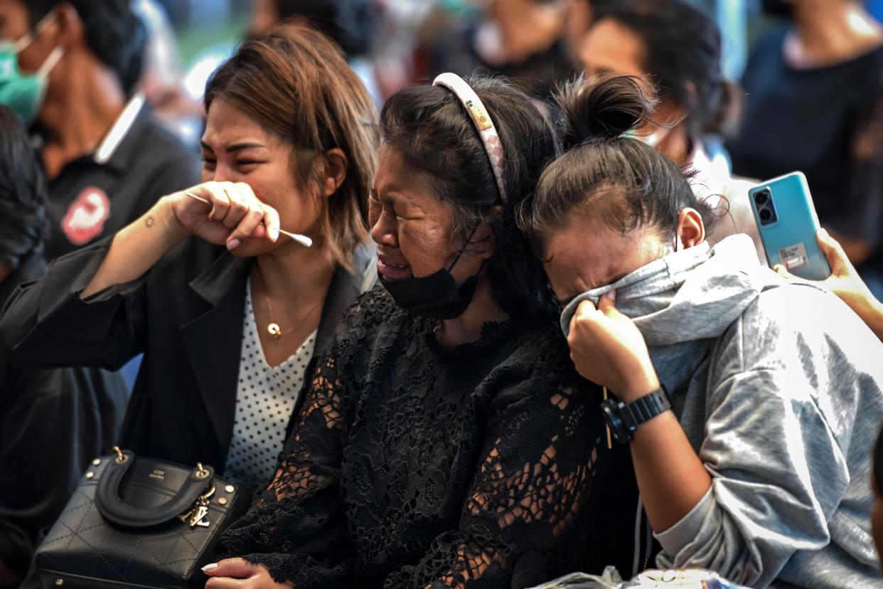 Relatives of victims cry as coffins are opened at Wat Si Uthai temple on Oct. 7, 2022 in Uthai Sawan subdistrict, Nong Bua Lamphu, Thailand. 