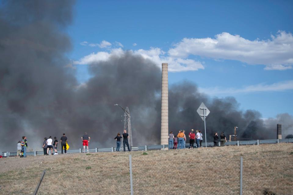 Curious onlookers line up along Interstate 25 to catch a glimpse of a fire burning at the Evraz Rocky Mountain Steel Mill on Friday, April 5, 2024.