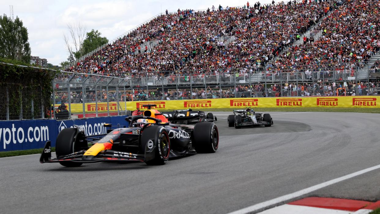  Max Verstappen taking a corner with Lewis Hamilton following closely behind 