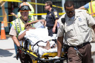 <p>Emergency personnel transport a victim from the scene where a cab jumped a curb striking several bystanders near the Logan International Airport taxi pool in Boston, MA, July 3, 2017. (Keith Bedford/The Boston Globe via Getty Images) </p>