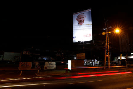 Cars pass in front of a poster of the Pope Francis ahead of his visit in Panama City, Panama January 21, 2019. REUTERS/Carlos Jasso