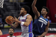 Detroit Pistons forward Saddiq Bey makes a lay up as Minnesota Timberwolves forward Anthony Edwards (1) defends during the second half of an NBA basketball game, Tuesday, May 11, 2021, in Detroit. (AP Photo/Carlos Osorio)