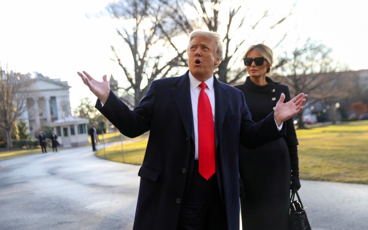 Donald Trump gestures as he and Melania Trump depart the White House  - Reuters