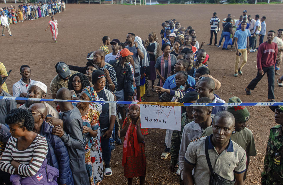 Voters wait for polling stations to open in Sierra Leone general elections in Freetown Saturday June 24, 2023. Sierra Leoneans are selecting their next president amid mounting frustration due to an ailing economy, rising unemployment and the loom of deadly protests. (AP Photo/TJ Bade)