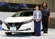 U.S. Open tennis champion Naomi Osaka (R) and Nissan Motor's Senior Vice President Asako Hoshino pose with Nissan Leaf electric car after a contract signing ceremony at Nissan's global headquarters in Yokohama, Japan, September 13, 2018. REUTERS/Toru Hanai