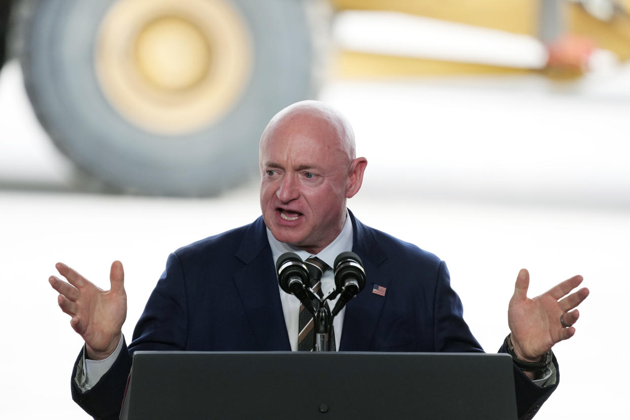 Arizona Sen. Mark Kelly speaking at a podium.