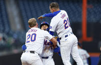 New York Mets' Pete Alonso (20) and Zack Short (21) congratulate Tyrone Taylor after he drove in the winning run against the Detroit Tigers during the ninth inning in the second game of a baseball doubleheader Thursday, April 4, 2024, in New York. The Mets won 2-1. (AP Photo/Noah K. Murray)