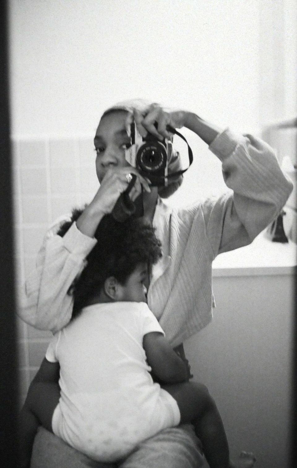 mother taking photo with baby