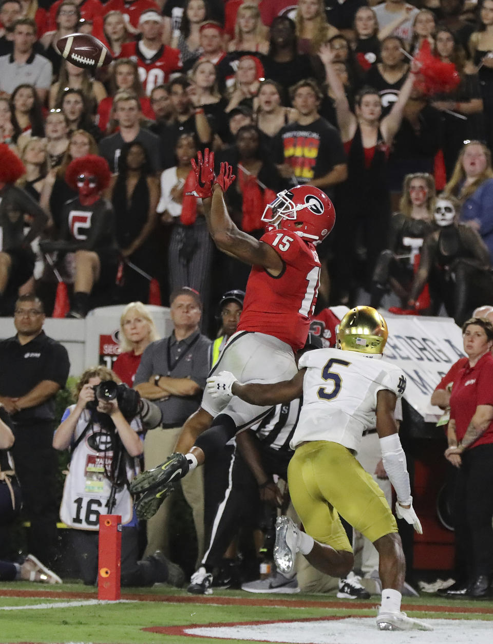 Georgia wide receiver Lawrence Cager catches a touchdown pass over Notre Dame cornerback Troy Pride Jr. during the fourth quarter of an NCAA college football game Saturday, Sept. 21, 2019, in Athens, Ga. (Curtis Compton/Atlanta Journal Constitution via AP)