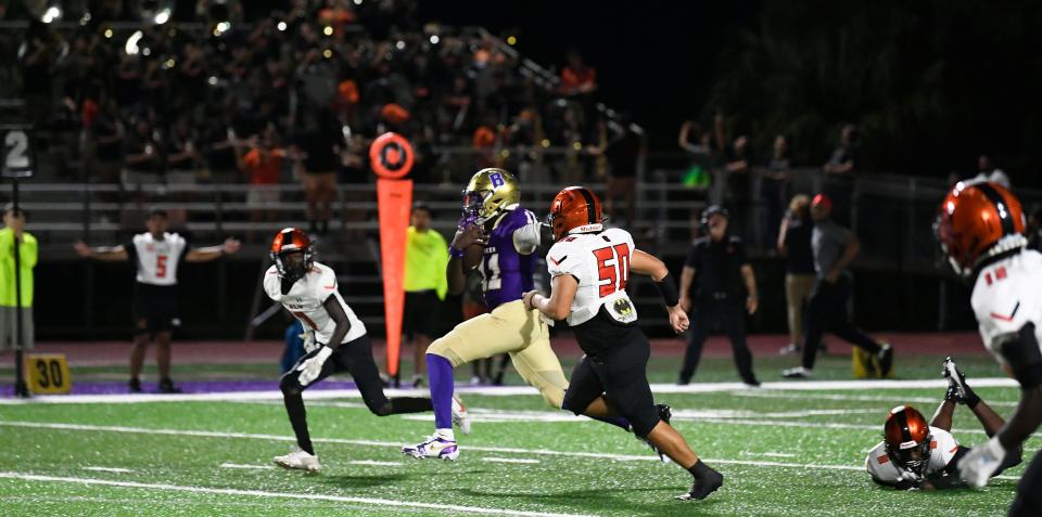 Booker's quarterback Joel Morris (#11) makes a big run during a quarterback keeper play. The Booker Tornadoes hosted the Lely Trojans (Naples, FL) Friday night, Aug. 23, 2024, who lost to Booker 46-0 during the first regular non-conference season game of the year.