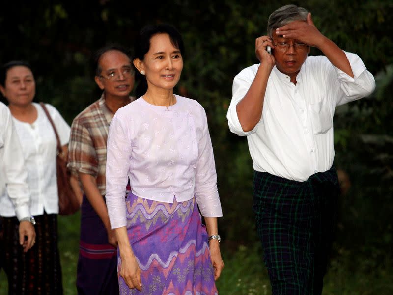 FILE PHOTO: Aung San Suu Kyi walks with National League for Democracy party members after being released from house arrest in Yangon