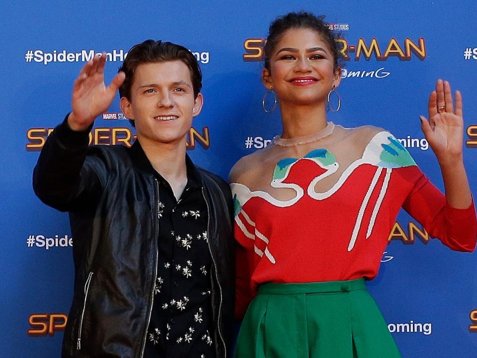 Tom Holland and Zendaya waving at a red carpet in Spain in June 2017.