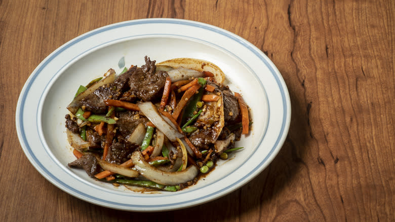 Beef and vegetables on white plate 