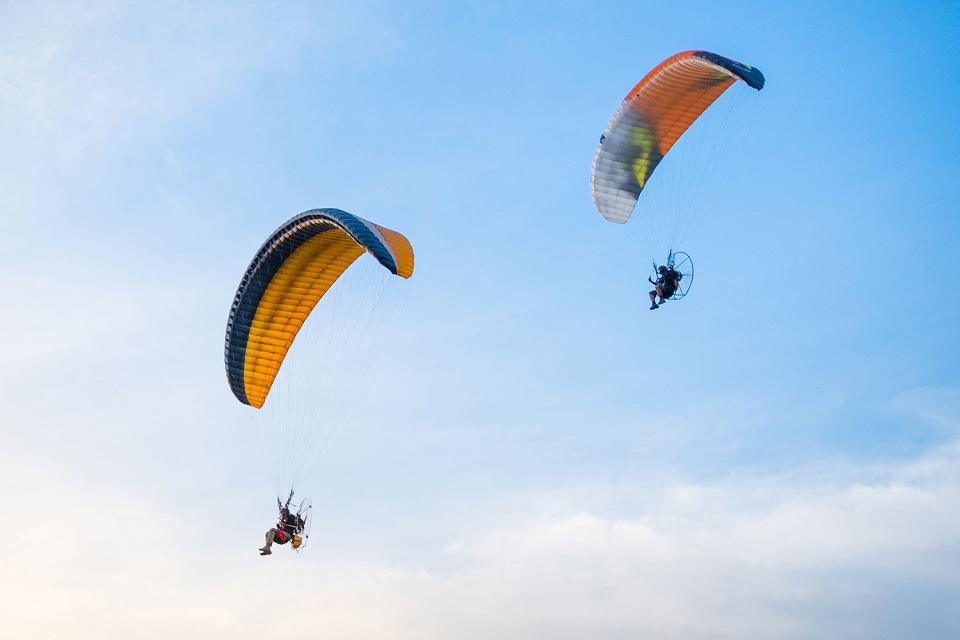 <p>Getty</p> Two paragliders photographed mid-air