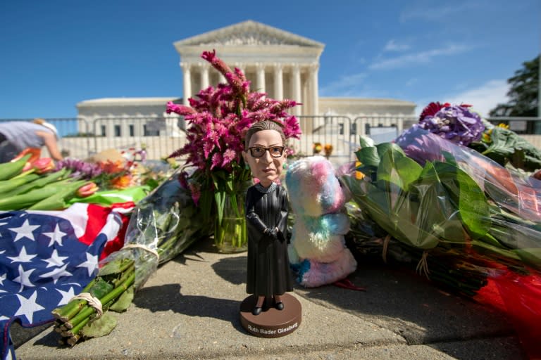 A bobblehead of US Supreme Court Justice Ruth Bader Ginsburg is left outside of the US Supreme Court in Washington, DC, on September 19, 2020 to honor her death
