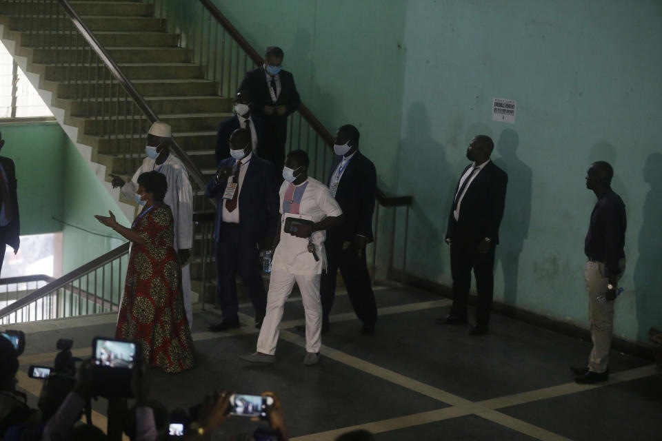 Ambassadors and foreign representations, leave after a meeting with Military junta led by Col. Mamady Doumbouya, at the people's palace in Conakry, Guinea Wednesday, Sept. 15, 2021. Guinea's junta is expected to face more pressure to set a timeframe for new elections Tuesday as the military rulers open a four-day series of meetings about the West African nation's future following the president's overthrow in a coup just over a week ago. (AP Photo/Sunday Alamba)