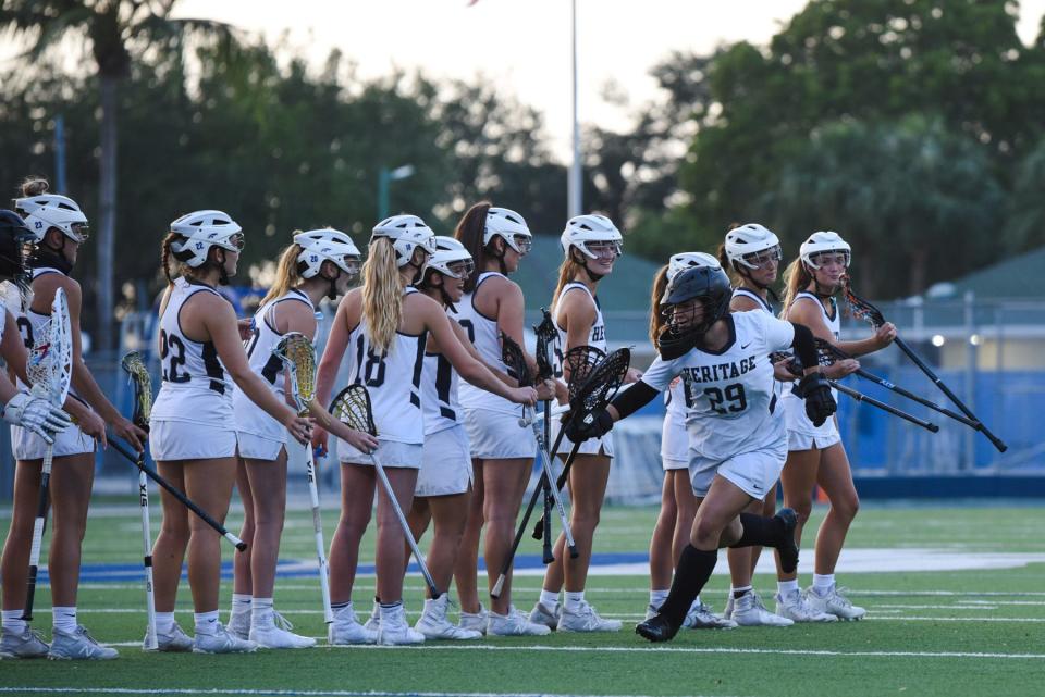 American Heritage goalie Brianna Valdivieso (29) greets her teammates as she takes the field before the Class 1A girls lacrosse regional semifinal between American Heritage and Benjamin at American Heritage in Delray Beach on April 22, 2021. Final score, American Heritage, 22, Benjamin, 9.