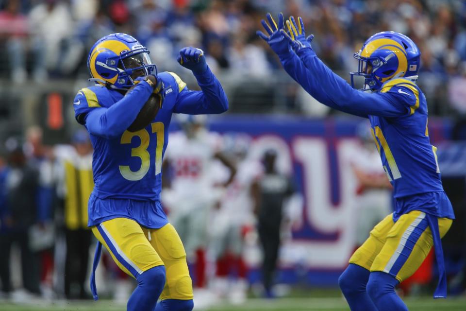 Rams cornerback Robert Rochell, left, celebrates his interception with Donte Deayon.