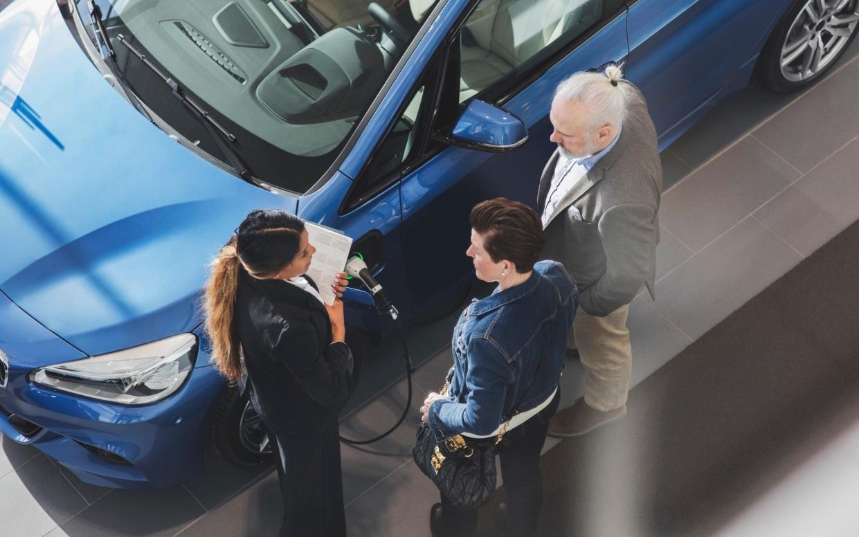 A stock image of an electric car being sold