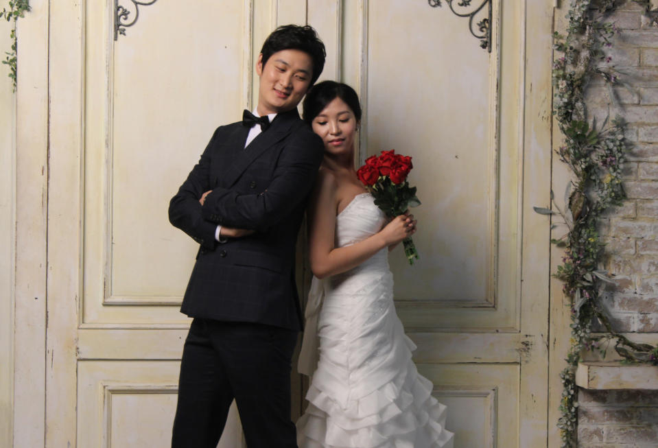 In this Tuesday, July 30, 2013 photo, Chen Jingjing, left, and Yang Candi of Beijing, China, strike a pose at a wedding studio in southern Seoul, South Korea, during an eight-hour photo session part of a South Korean wedding tourism package for Chinese couples. China is the source of one quarter of all tourists to South Korea, and a handful of companies in South Korea’s $15 billion wedding industry are wooing an image-conscious slice of the Chinese jet set happy to drop several thousand dollars on a wedding album with a South Korean touch. (AP Photo/ Elizabeth Shim)