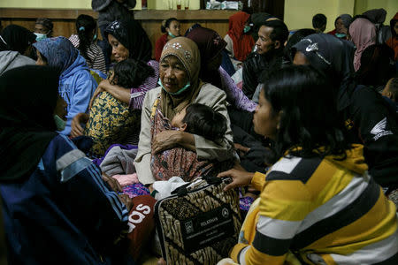 Villagers living near Mount Merapi volcano take shelter in a village hall following a series of minor eruptions in Cangkringan, Sleman, Yogyakarta, Indonesia May 21, 2018 in this photo taken by Antara Foto. Picture taken May 21, 2018. Antara Foto/ Hendra Nurdiyansyah/ via REUTERS